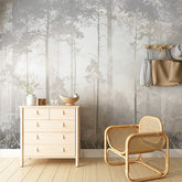 A serene wallpaper of a misty forest with tall trees and delicate wildflowers in the foreground.